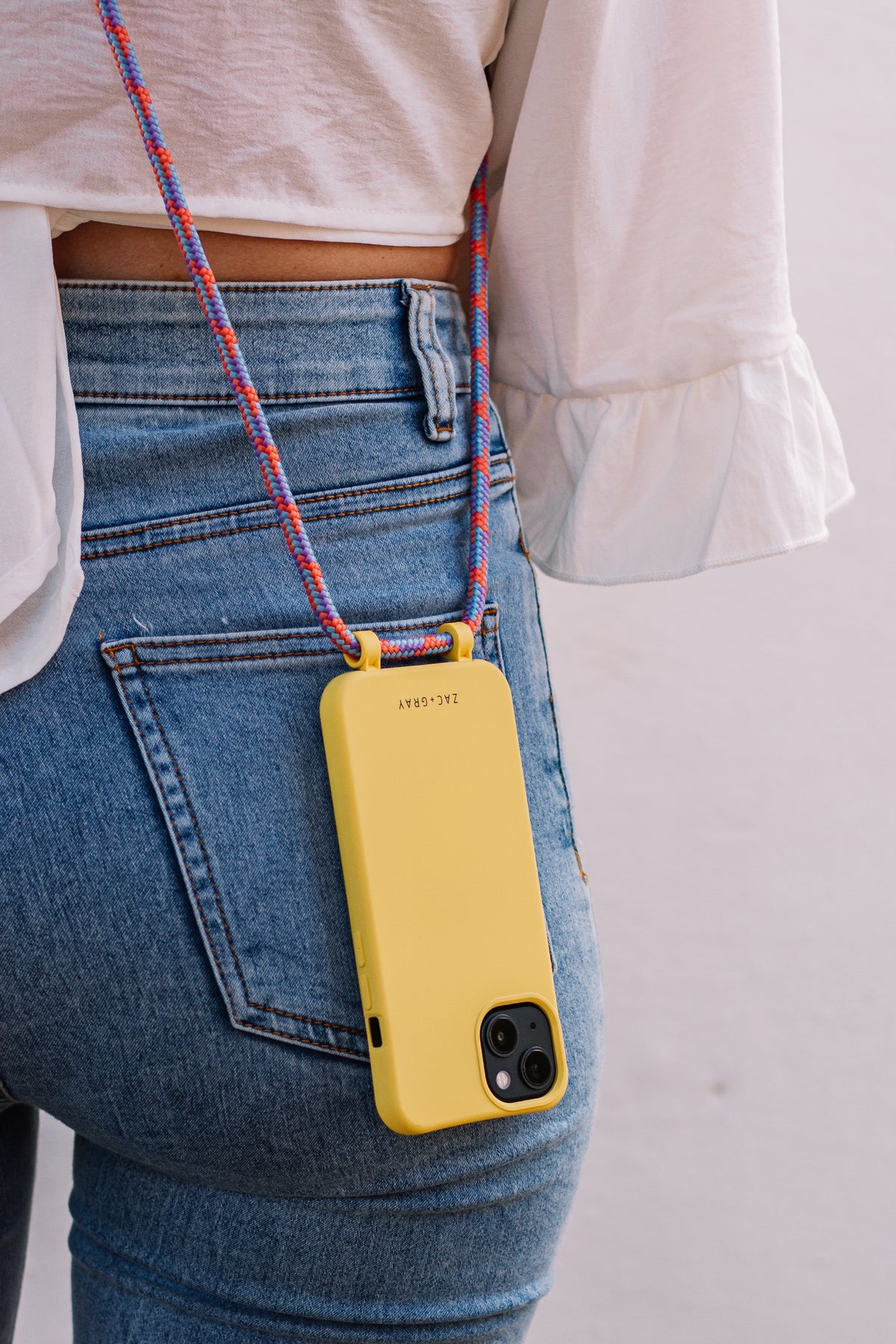 a woman is holding a cell phone in her pocket