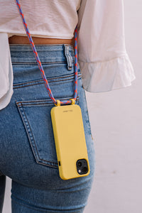 a woman is holding a cell phone in her pocket