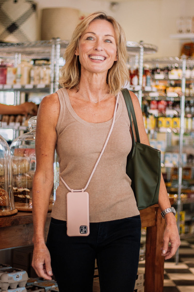 a woman standing in a store holding a purse