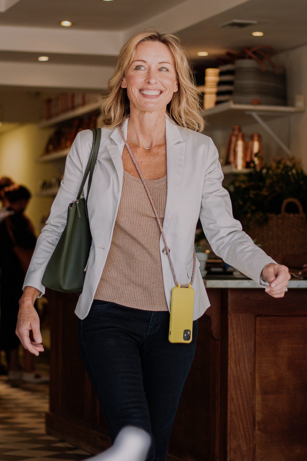 a woman in a white blazer and a yellow purse