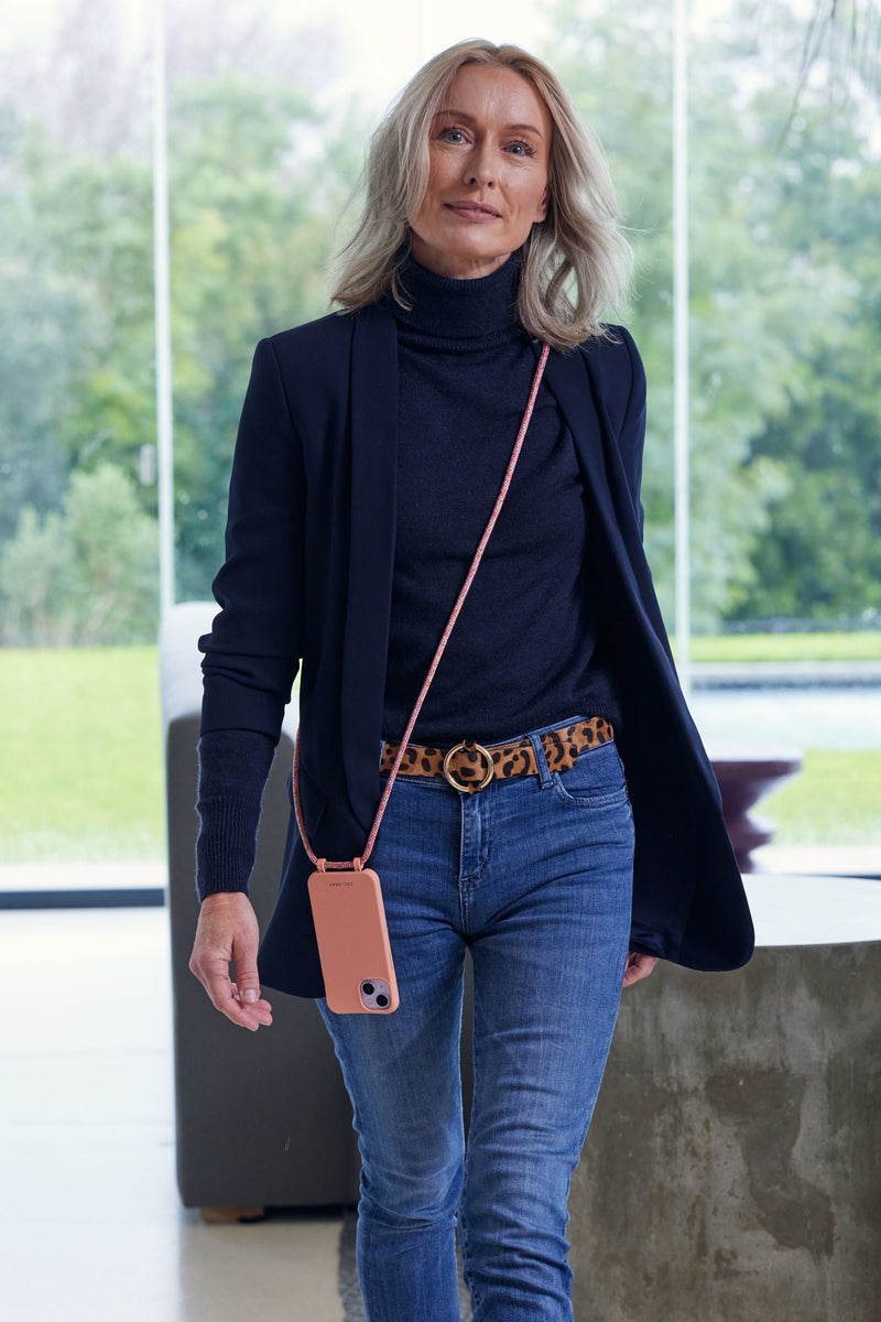 a woman in a black top and jeans is walking