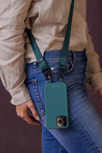 a person holding a cell phone in their back pocket