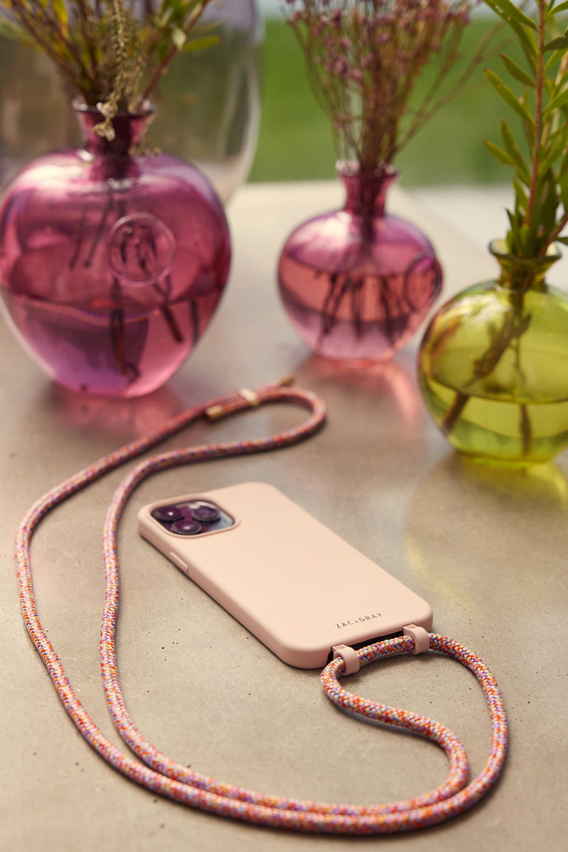 a pink phone case sitting on top of a table