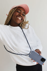 a woman in a pink hat is holding a cell phone